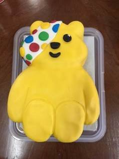 A yellow bear shaped cake
AI-generated content may be incorrect.