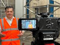 A person in orange vest and a video camera

AI-generated content may be incorrect.